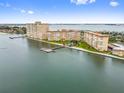 Stunning aerial view of condo buildings by the water, featuring lush green spaces and boat docks at 5200 Brittany Dr. S # 706, St Petersburg, FL 33715