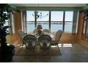 Bright dining area with water views, glass table, chandelier, and elegant decor at 5200 Brittany Dr. S # 706, St Petersburg, FL 33715