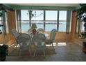 Bright dining area with water views, glass table, chandelier, and elegant decor at 5200 Brittany Dr. S # 706, St Petersburg, FL 33715