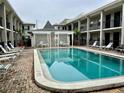 Community pool surrounded by seating and patio area in a courtyard at 5221 Bayshore Blvd # 29, Tampa, FL 33611