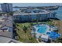 Aerial view of a condo complex featuring a large, heart-shaped pool and lush landscaping at 5277 Isla Key S Blvd # 422, St Petersburg, FL 33715