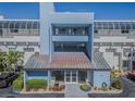 Exterior shot of a building with blue facade and a unique architectural design at the entrance at 5277 Isla Key S Blvd # 422, St Petersburg, FL 33715