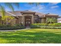 Charming home featuring a covered entryway with beautiful landscaping, and double doors at 7226 Bryce N Pt, Pinellas Park, FL 33782