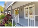 Inviting front porch showcasing a wooden door, decorative lizard accent, and lush, well-maintained landscaping at 734 Newton S Ave, St Petersburg, FL 33701