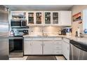 Bright kitchen with white cabinets, stainless steel appliances, and granite countertops at 841 4Th N Ave # 57, St Petersburg, FL 33701