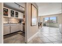 Cozy kitchen with white cabinets, stainless steel appliances, and tile flooring leading to dining area at 841 4Th N Ave # 57, St Petersburg, FL 33701
