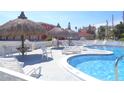 Community pool featuring plenty of seating, umbrellas, and clear water to enjoy at 8567 W Gulf Blvd # 17N, Treasure Island, FL 33706