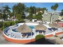 Relaxing community pool area with tiki umbrellas and plenty of seating for residents at 8567 W Gulf Blvd # 17N, Treasure Island, FL 33706