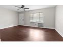 A bright bedroom with a ceiling fan and large window with lots of natural light at 9307 N 27Th St, Tampa, FL 33612