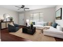 Bright living room with a cozy sectional sofa, modern furnishings, and a ceiling fan at 9307 N 27Th St, Tampa, FL 33612