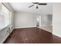 Living room featuring wood-look flooring, a ceiling fan, and natural light at 9307 N 27Th St, Tampa, FL 33612