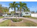 Inviting single-story home with tropical landscaping, a circular driveway, and a serene curb appeal at 1003 39Th Ne Ave, St Petersburg, FL 33703