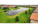 Scenic backyard view featuring lush greenery, a tranquil pond, and meticulous landscaping at 10213 Saint Francis Ter, Palmetto, FL 34221