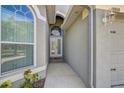 Property entrance featuring a gray exterior with white trim and an arched glass door at 10810 Moss Island Dr, Riverview, FL 33569
