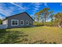 A spacious backyard with a well-maintained lawn, ideal for outdoor activities and relaxation at 122 Jennifer Dr, Rotonda West, FL 33947