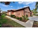 Charming single-story home with a well-manicured lawn, sidewalk, and beautiful landscape beds at 178 Shell Falls Dr, Apollo Beach, FL 33572