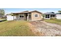 Charming one-story home showcasing a covered porch and modest landscaping in a residential neighborhood at 1819 Shore Acres Ne Blvd, St Petersburg, FL 33703
