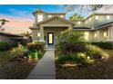 Charming home featuring a covered front porch, blue door, landscape lighting and vibrant flowers at 208 W Amelia Ave # 1, Tampa, FL 33602