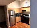 Efficient kitchen featuring stainless steel refrigerator and black appliances at 2320 W Azeele St # 317, Tampa, FL 33609