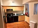 Well-lit kitchen boasts wood floors and black appliances at 2320 W Azeele St # 317, Tampa, FL 33609