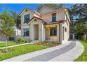 Beautiful two-story home showcasing a well-manicured lawn and a stylish, neutral-toned facade at 2618 15Th N Ave, St Petersburg, FL 33713