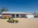 Charming single-story home featuring brick accents, well-kept landscaping, and a two-car garage at 3729 Sail Dr, New Port Richey, FL 34652