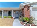 Charming front entrance with brick accents, well-maintained landscaping, and a welcoming pathway at 3729 Sail Dr, New Port Richey, FL 34652
