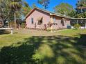 Exterior view of the home showcasing the lush lawn, garden and overall curb appeal at 402 8Th Sw St, Ruskin, FL 33570