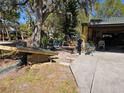 Exterior of home with a large tree in the yard at 402 8Th Sw St, Ruskin, FL 33570