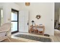 Inviting foyer with tile flooring, light walls, and a decorative table for displaying personal touches at 4078 Salem Square Pkwy, Palm Harbor, FL 34685