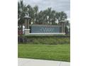 A beautiful community sign with palm trees in the background for the 'Aviary at Rutland Ranch' at 6024 162Nd E Ave, Parrish, FL 34219