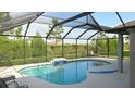 Screened-in outdoor pool featuring a built-in waterfall and plenty of space for lounging at 6024 162Nd E Ave, Parrish, FL 34219