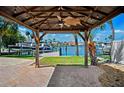Dock and gazebo offer scenic waterfront views in a backyard that is perfect for relaxing at 6410 3Rd Palm Pt, St Pete Beach, FL 33706