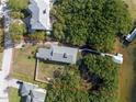 Aerial view of property boundaries with dock, boathouse, and surrounding green space at 734 Weedon Ne Dr, St Petersburg, FL 33702