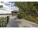 Picturesque dock with a boat lift and waterfront views surrounded by lush vegetation at 734 Weedon Ne Dr, St Petersburg, FL 33702
