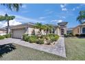 Charming single-story home boasts lush landscaping with a fountain and manicured garden beds at 830 Regal Manor Way # 1, Sun City Center, FL 33573