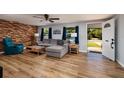 Inviting living room featuring wood-look floors, a comfortable gray sofa, and stylish decor at 8871 94Th St, Seminole, FL 33777
