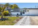 Charming single-story home with well-manicured front yard and inviting entrance featuring decorative rock and pathway at 9172 82Nd Way, Seminole, FL 33777