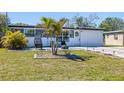 Landscaped front yard with palm tree and modern exterior design create a welcoming curb appeal at 9172 82Nd Way, Seminole, FL 33777