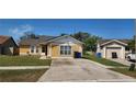 Charming single-Gathering home with well-maintained lawn, neutral color scheme, and a detached one car garage at 2108 Ridgemore Dr, Valrico, FL 33594