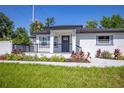 Beautifully renovated single-story home with a modern black railing and landscaped front yard at 1102 N Albany Ave, Tampa, FL 33607