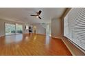 Spacious living room featuring hardwood floors, ceiling fan, and access to the outdoor patio at 12426 Country White Cir, Tampa, FL 33635