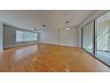 Bright and airy living area with hardwood floors and sliding glass doors to a covered patio at 12426 Country White Cir, Tampa, FL 33635