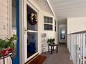 Welcoming entrance featuring a decorative wreath on the door and a cozy covered porch at 272 S Port Royal Ln, Apollo Beach, FL 33572