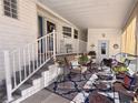 Inviting covered porch with comfortable seating and a decorative rug, perfect for relaxing at 272 S Port Royal Ln, Apollo Beach, FL 33572