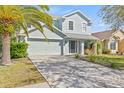 Charming two-story home with a well-manicured lawn, large driveway, and a two-car garage at 2944 Billingham Dr, Land O Lakes, FL 34639