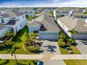 Aerial view of a charming single-Gathering home featuring a well-manicured lawn and beautiful palm trees at 318 Blackrock Ln, Apollo Beach, FL 33572