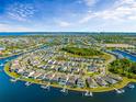 Wide aerial view of a sprawling waterfront community with docks and direct access to the ocean at 318 Blackrock Ln, Apollo Beach, FL 33572