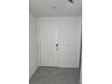 Bright entryway featuring tile flooring and a white front door at 36562 Silver Maize Dr, Dade City, FL 33525