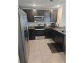 Modern kitchen featuring stainless steel appliances and dark cabinets at 36562 Silver Maize Dr, Dade City, FL 33525